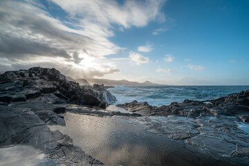 waves beating against the rocks in El Puertillo at sunset. Arucas. Gran Canaria. Canary islands