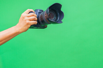 Camera in hands on isolated green screen