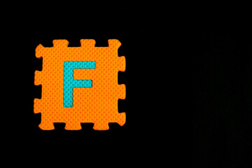 Colorful alphabet puzzle isolated on black background. alphabet learning block for children education.
