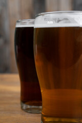 Brew. Closeup view of two beers, an amber ale and an ipa.