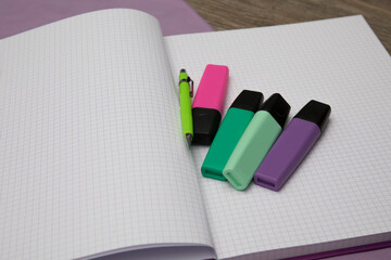 colored markers on notebooks