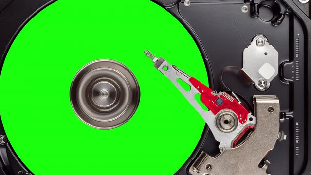 HDD platter on rotating spindle. Chromakey plate inside working hard drive. Seamless loop, stop motion