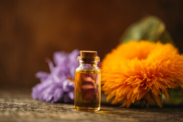 bottle of oil and flowers