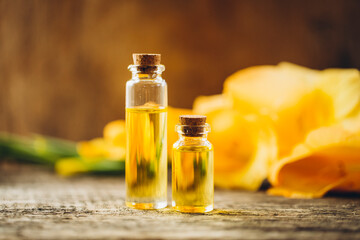 oils with flowers. Oil bottle. Flowers. Wooden table. Photo. Background. Bottle. Aroma.