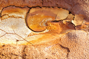 Conspicuous dry cracked mineral waste puddle in abandoned mine in Mazarrón, Murcia