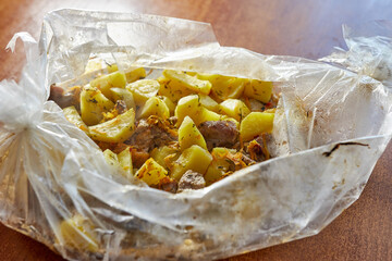 Freshly cooked hot potatoes and meat dish.