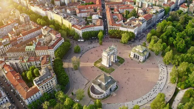 Aerial view of Arco della pace Milano Lombardia imperial monument in center drone flight shot over city round square in Italia historic monument sunny day looking from above feat baroque architecture