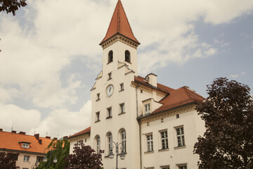 Beautiful town hall in a European city, Old building with a tiled roof, Clock tower.urban background