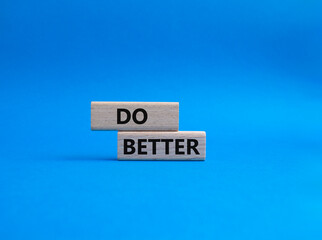 Do better symbol. Wooden blocks with words Do better. Beautiful blue background. Business and Do better concept. Copy space