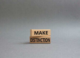 Make distinction symbol. Concept words make distinction on wooden blocks. Beautiful grey background. Business and make distinction concept. Copy space