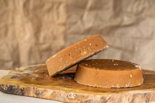 colombian panela or sugar cane candy, ready to be consumed in various typical dishes. piloncillo ready for sale and commercialization, placed on a wooden board and a warm background. food concept