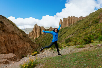 Happy female tourist is jumping. Canyon de Palca .La Paz, Bolivia.
