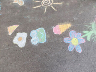 Children background. A child drawing in chalk on concrete asphalt.