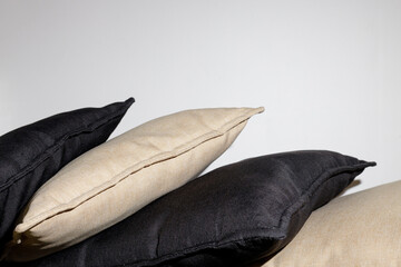 Black and brown pillows on the bed on a gray background. Modern interior design