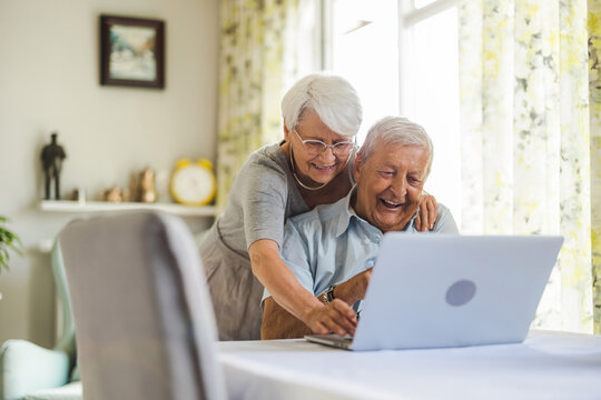 Happy Senior Couple Using Laptop At Home
