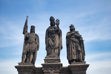 Fototapeta na wymiar Statue of Saints Norbert of Xanten, Wenceslas and Sigismund on Charles bridge, Prague. Czech Republic