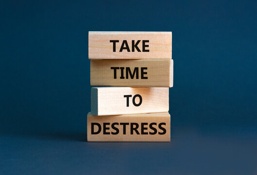 Take time to destress symbol. Concept words Take time to destress on wooden blocks. Beautiful grey table grey background. Psychological business and take time to destress concept. Copy space.
