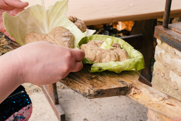Baking bread in the oven on cabbage leaves