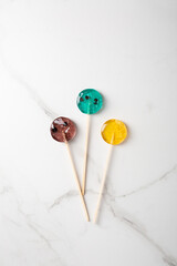 Overhead view of homemade fruits lollipops on light background