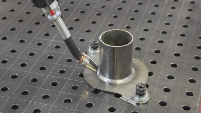 Automated Welding Robot Process Metal Pipe at Work Table