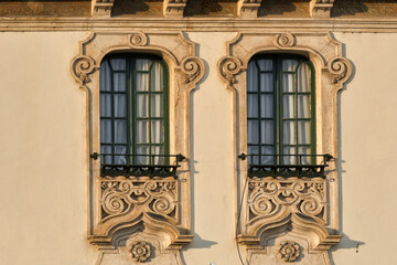 Fototapeta na wymiar Building with windows and doors with stone panel with floral patterns in Leiria, Portugal