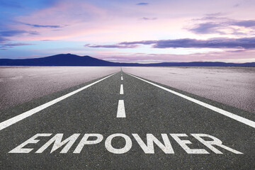 Empower text on a road for empowerment concept.