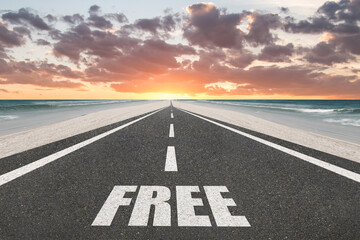The word Free on a highway leading to the horizon.
