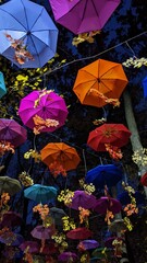 multi-colored umbrellas hung in the autumn night sky
