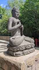 Fototapeta na wymiar giant buddha statue sitting in lotus position against blue sky