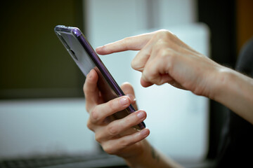 Woman holding smartphone in office