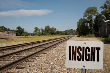 Insight sign for new ideas concept with train tracks leading to the horizon.