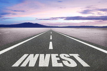 The word Invest on a beautiful highway motivation concept.