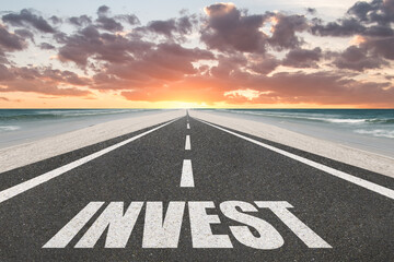 The word Invest on a beautiful highway.