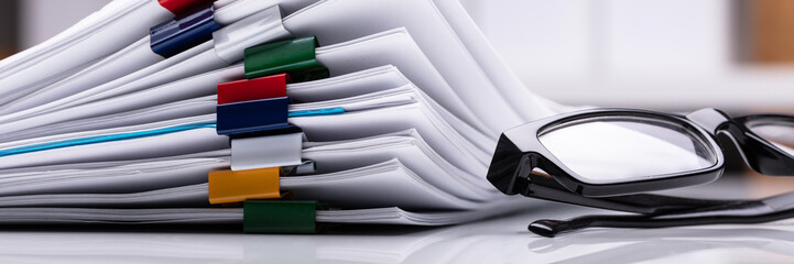 Stacked Documents And Eyeglasses
