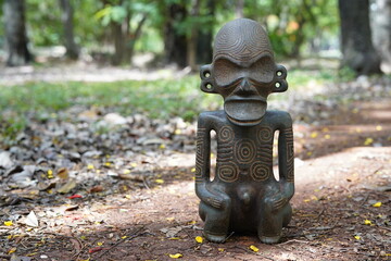 Taino Antique Stone Idol God Figure standing on the grown, close up. Taino Indian Mythology.