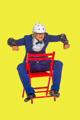 a cheerful guy poses in a white helmet and a blue jacket on a white background isolated in the studio. the guy shows a motorcycle. imitates riding a bike on a motorcycle