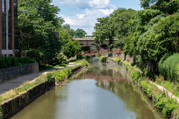 The C & O Canal runs through the Georgetown area in Washington, DC. The Francis Scott Key Bridge is in the background.