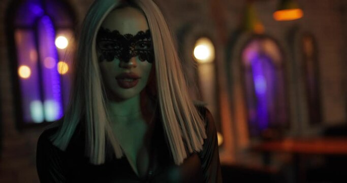 Sexy attractive frisky woman in dress posing in the night bar