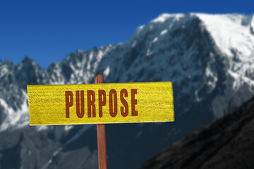 Purpose sign with snowy mountain in background.
