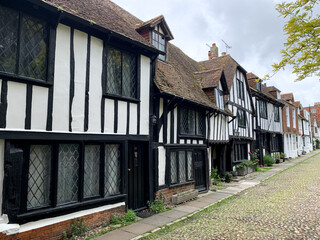 Church square view in Rye East Sussex England UK Charming medieval street in old town Picturesque countryside Old cozy medieval tudor half-timbered house cottage. Summer in Rye. Charming medieval town
