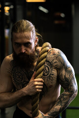 Fototapeta na wymiar Rope tug man pirate pull invisible was casual power male, concept competition struggle from isolated from pulling white, job balance. Men ABS alone, beard