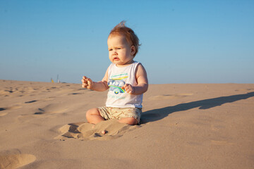 baby boy playing with sand on the beach.Summer, summer vacation at sea,vacation. Baby up to one year old.