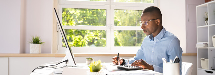 Businessman Calculating Bill