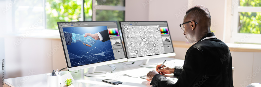 Poster designer editing photos on computer