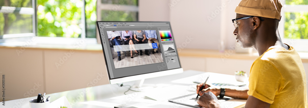 Poster Designer Editing Photo On Computer