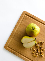 pears and walnuts on a cutting board