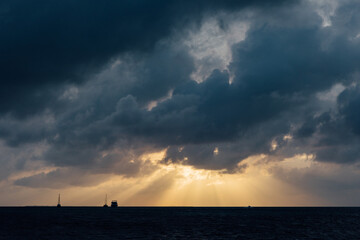 Intense sun rays coming through the clouds over the ocean in Belize
