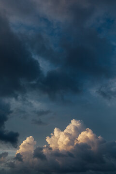 Dramatic puffy bright and dark clouds over the ocean