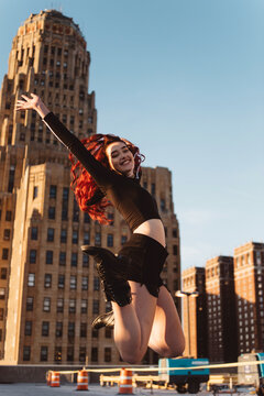 A teenage girl hanging out in the city at sunset