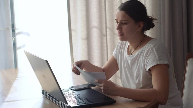 Authentic Caucasian Young Woman Chatting On Laptop At Home In Living Room. Writing Searching Using IT At Desk. Happy Lady Working On Computer Browsing Internet. Buisenes, Education, Technology Concept
